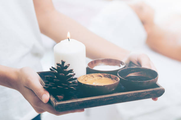 istock Massage therapist with hot spa treatment set. 977684498
