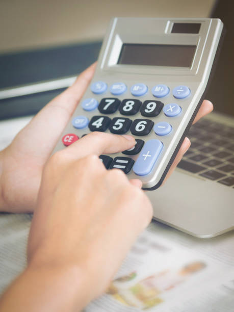 istock Woman accountant or bank worker uses calculator. 977684576