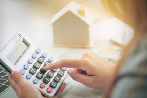 istock Woman accountant or bank worker uses calculator. 977684598