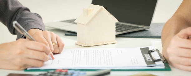 istock Client Signs Document to Buy House and Real Estate 977684620