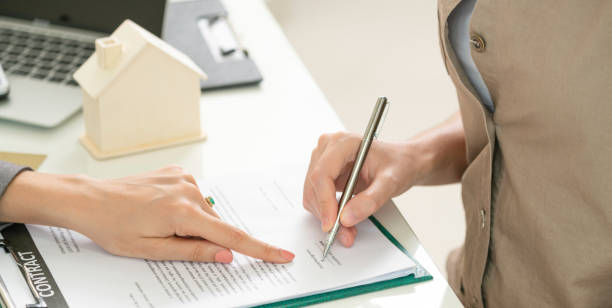 istock Client Signs Document to Buy House and Real Estate 977684632