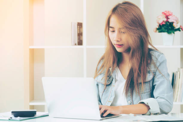 istock Concentrated woman works on computer in home office. 977684640