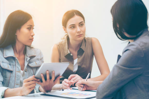 istock Multicultural businesswomen in group meeting. 977684652