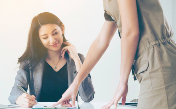 istock Businesswoman reads and talks with partner. 977684678