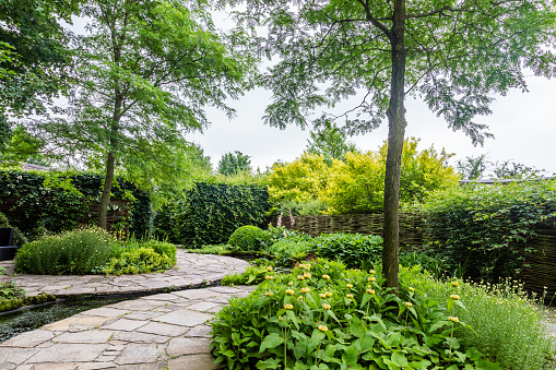 Garden design with water element and rounded flagstones