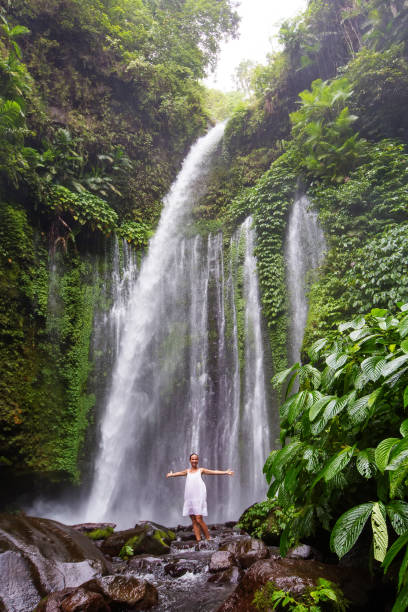 istock Woman meditating doing yoga between waterfalls 977697248