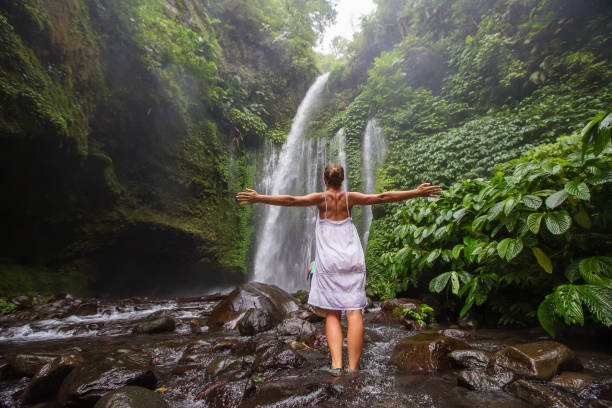 istock Woman meditating doing yoga between waterfalls 977697256