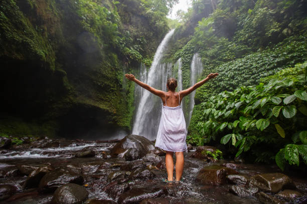 istock Woman meditating doing yoga between waterfalls 977697260