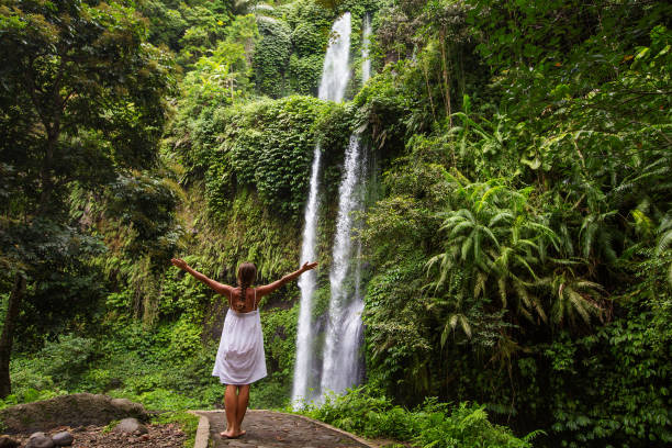 istock Woman meditating doing yoga between waterfalls 977697298