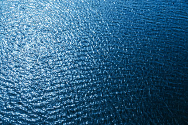 istock turquoise water with waves and reflections. water texture or background 977705494