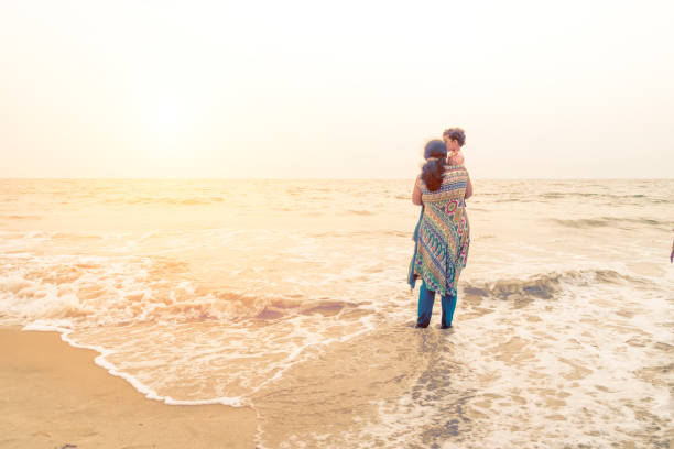 istock mother and daughter in beach 977715264