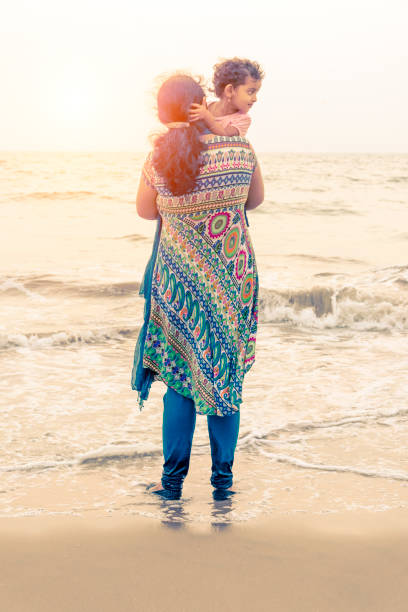 istock mother and daughter in beach 977715296