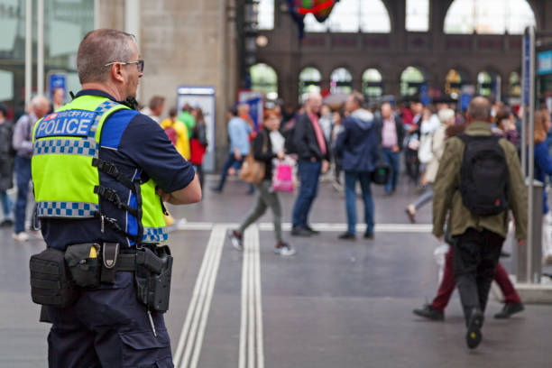 Swiss railroad police officer Zurich, Switzerland - June 13 2018: Police officer from the railway police checking at the crowd of travellers in Zürich Hauptbahnhof railway station. zurich train station stock pictures, royalty-free photos & images