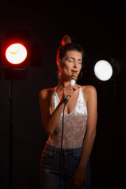 istock A woman sings a song in the studio 977725004