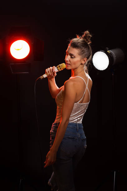 istock A woman sings a song in the studio 977725022
