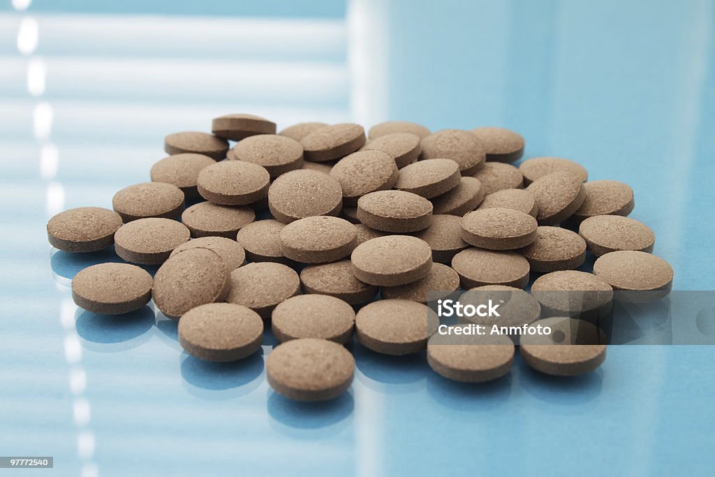 Brown tablets on a blue background  Backgrounds Stock Photo
