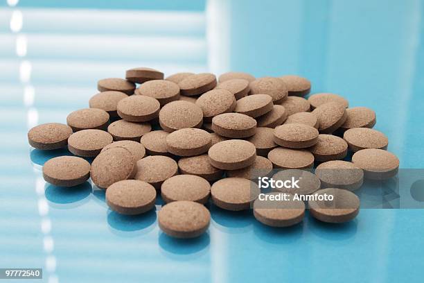 Brown Tablets On A Blue Background Stock Photo - Download Image Now - Backgrounds, Blue, Brown