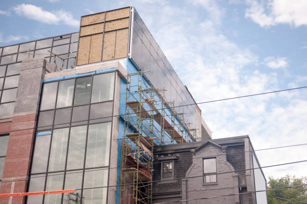 istock New building construction beside an old house 977740746