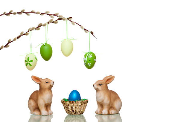istock Cute Easter bunnies sitting beside nest with colorful egg 97774717