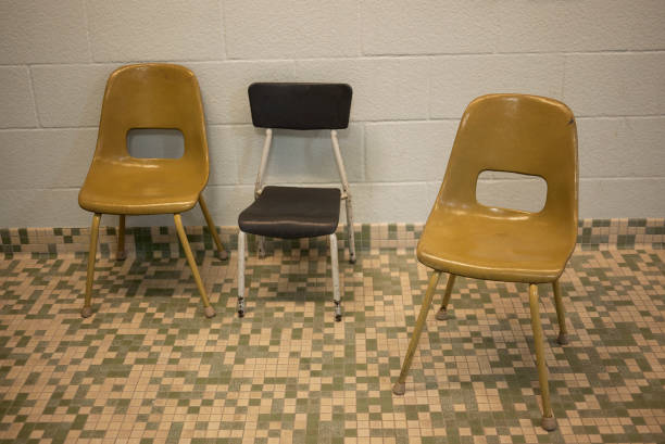 istock Child sized chairs by side of pool 977753478