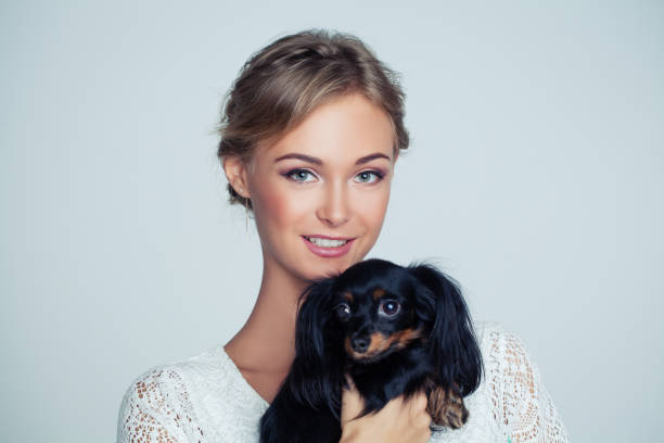 istock Young Woman Hugging Small Dog, Portrait 977758110