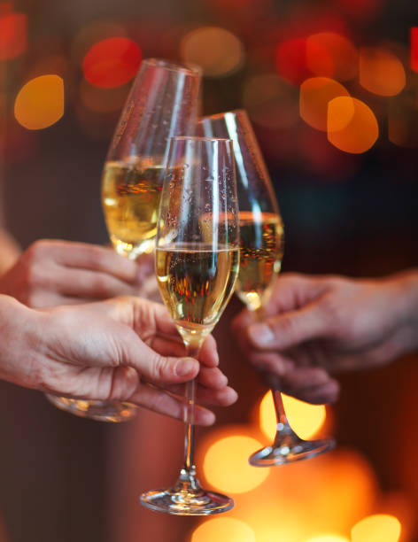 istock Champagne glasses on red and yellow bokeh background 977758814