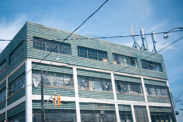 istock Old industrial building with cell towers on top. 977769880