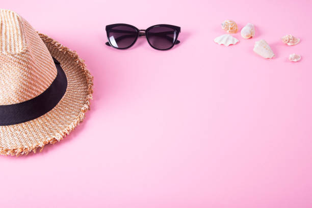 istock Sunglasses, hat and shells on pink background. Top view. Flat lay. 977782260
