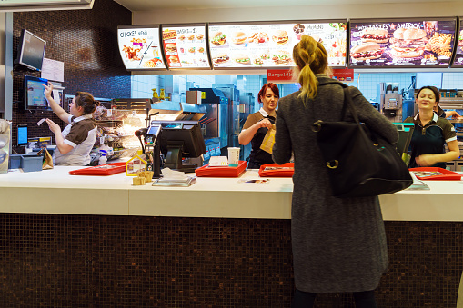 Munich, Germany - October 24, 2017: The girl receives an order in the interior of the McDonald's fast-food restaurant