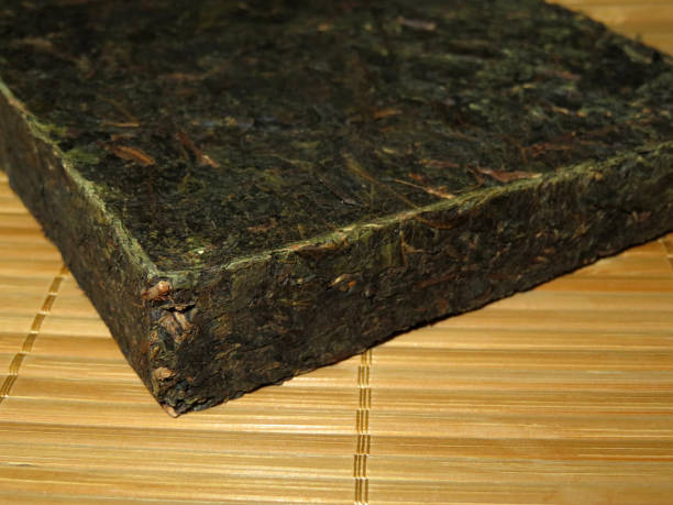 istock Brick of chinese dark tea on bamboo surface 977817304