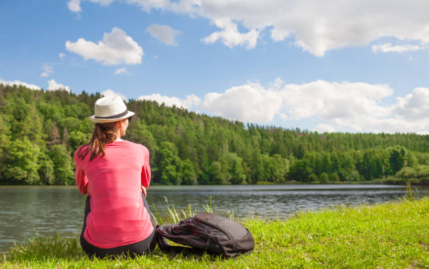 istock Woman relaxes by the lake 977818240