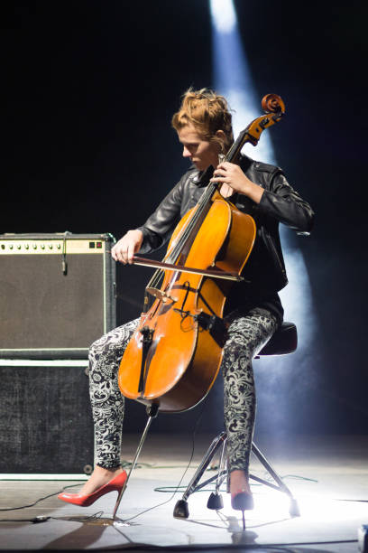 istock Young woman playing cello on the stage 977831000