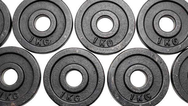 istock Black metal weights 1kg on white background with clipping path. 977835320