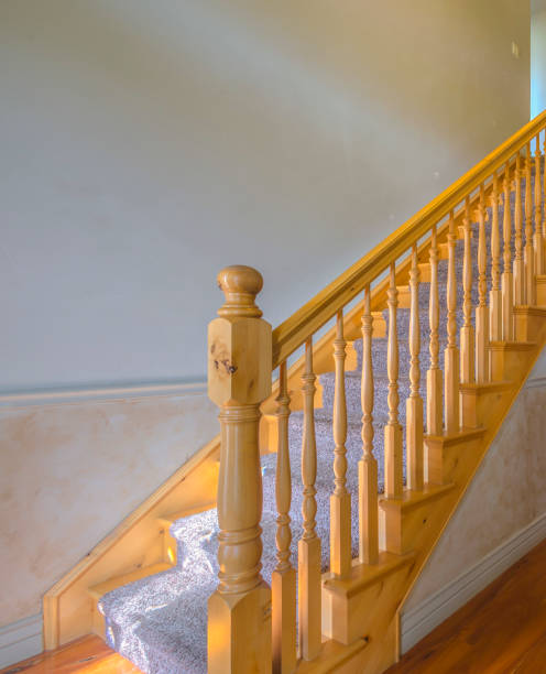 istock Carpet stairs with wood railing in home 977842478