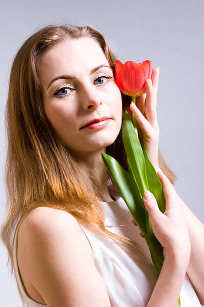 istock Beautiful young woman holding tulip 97787461