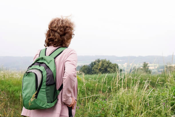 istock Senior woman hiking on mountain 977881736