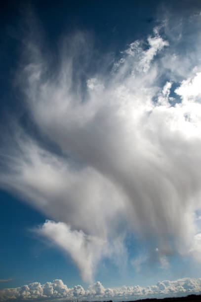 istock Dramatic clouds with showers over open farm land 977882616