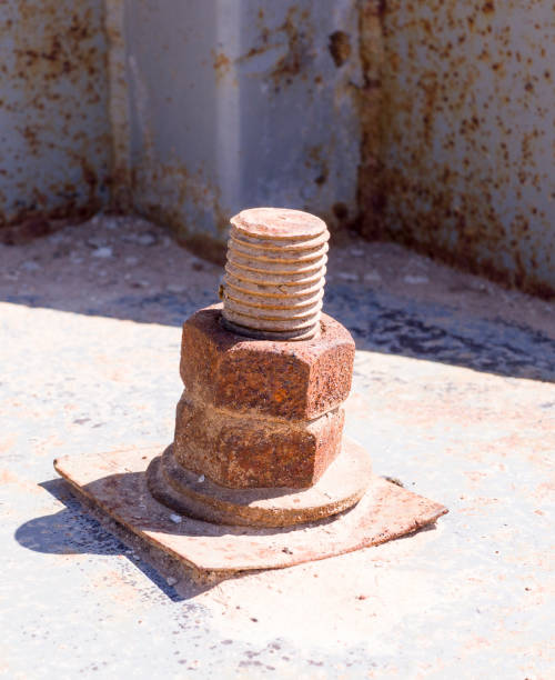 istock rusty screw with nut at sunny day. industrial concept 977934562