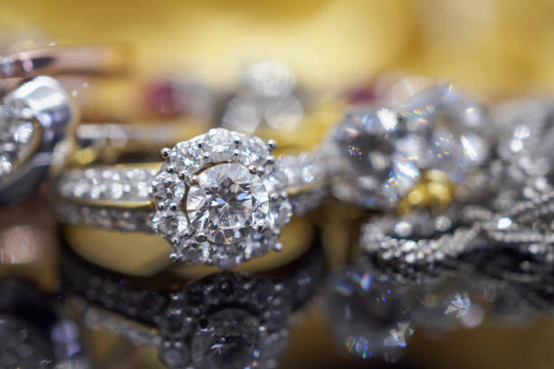 istock Luxury gold Jewelry diamond rings with reflection on black background 977976656