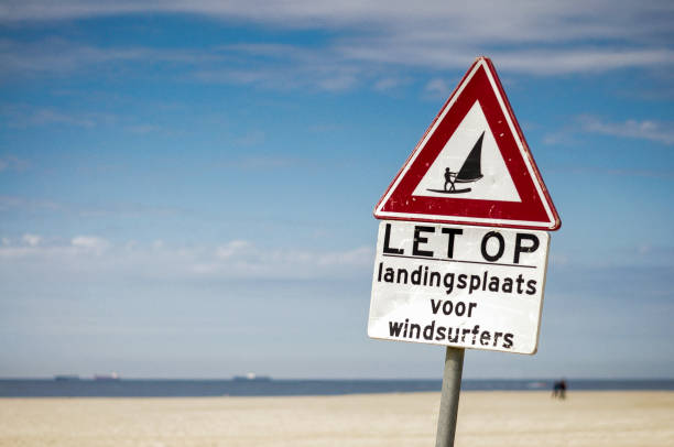 istock Windsurfers sign on the beach 977983582