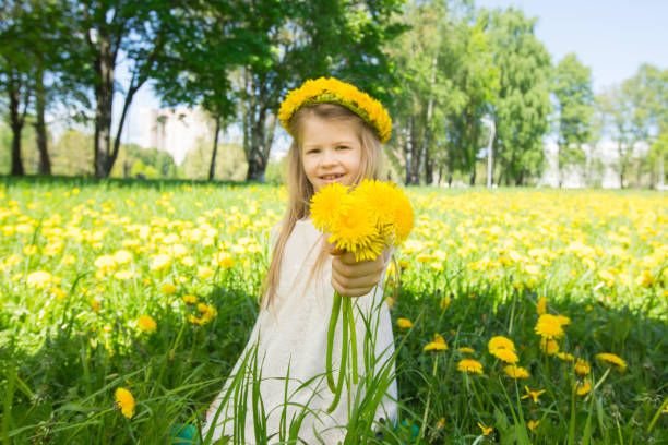istock Girl with floral head wreath and bunch 977985194