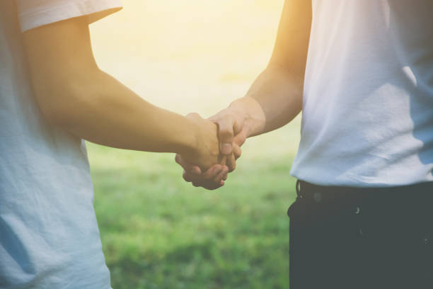 istock Two men volunteer handshake for congratulate each other 977992638