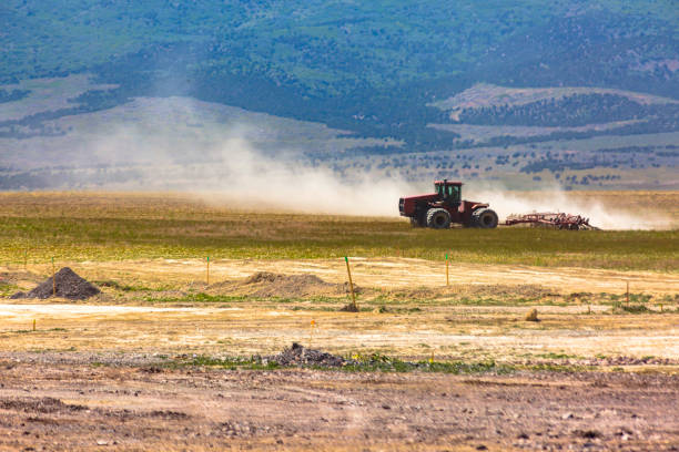 istock A tractor in the distance kicking up dust 977993364