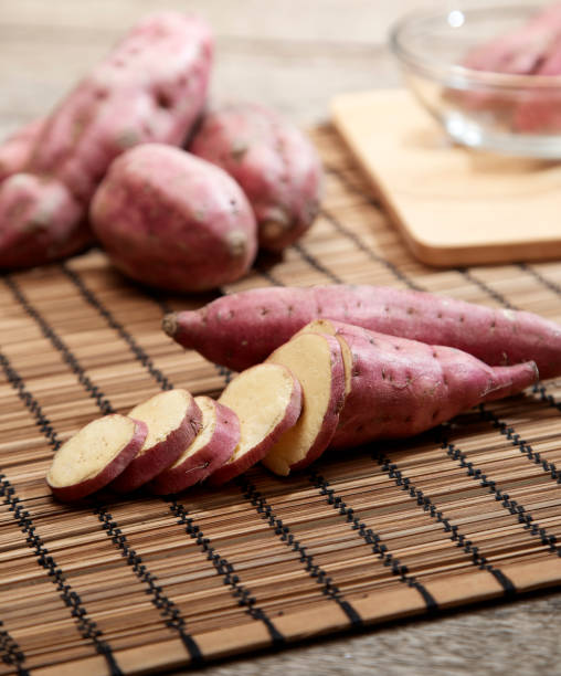 istock Raw sweet potato on wooden table 978023080