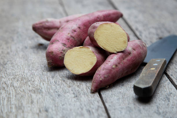 istock Raw sweet potatoes on wood background 978023100