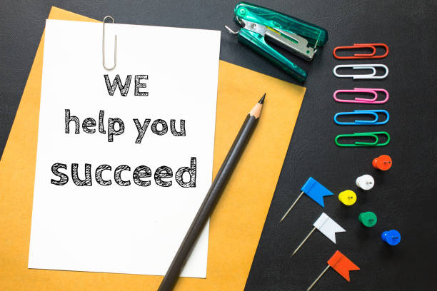 istock Text we help you succeed on white paper background / business concept 978058984