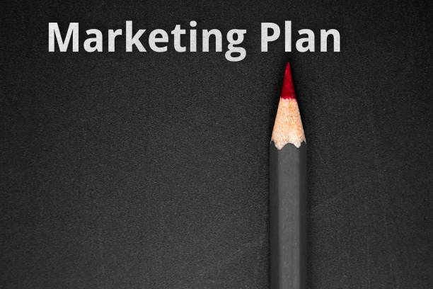 istock Text Marketing plan with pencil on black / save the date concept 978098102