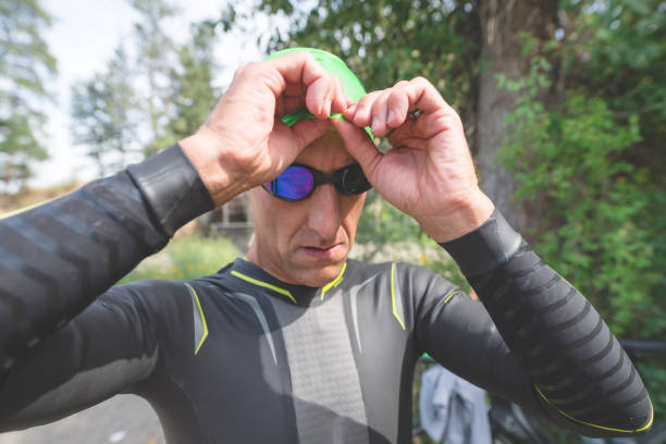 istock Male Triathlete Adjusts His Goggles Before the Swim Stage 978132356