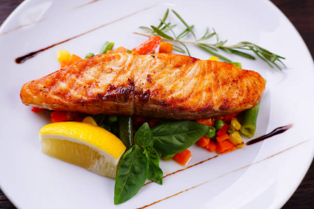 istock Grilled salmon steak with vegetable garnishing 978148910