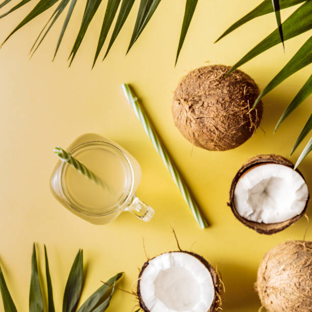 istock Coconut water and coconuts on a background with tropical leaves 978149514